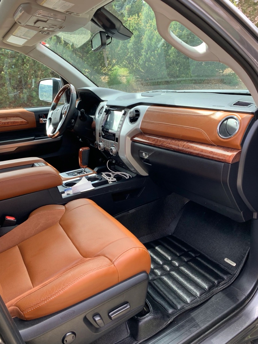 Truck interior with leather seats and floor liners after a full interior detail