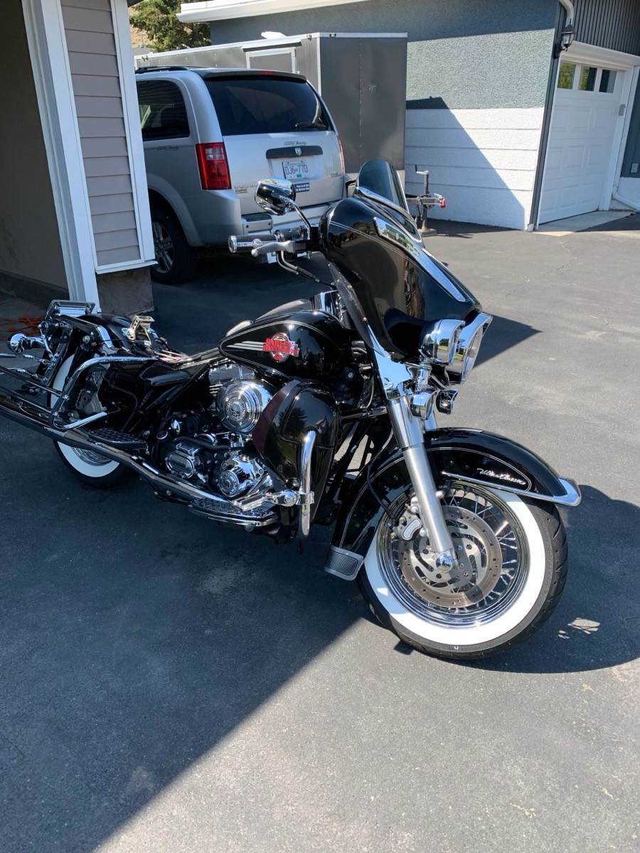 Black touring motorcycle washed and polished in a driveway by Miner Details
